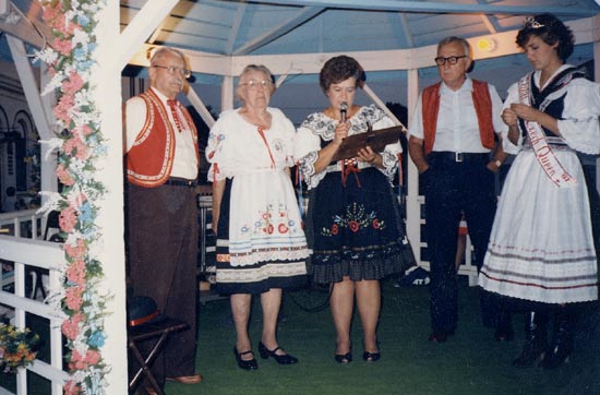 Walter and Helene Baer, Anna Janecek Salda, the presenter, with Eugee Zajicek and Lisa Karpisek, 1986 Miss Nebraska Czech Queen