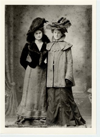 W42, two women standing wearing hat, gloves and coat