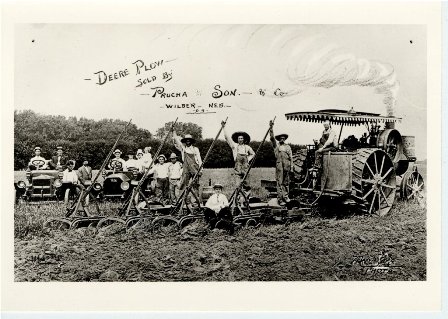 W64, Deere Plow sold by Prucha & Son & Co. Wilber, Nebraska with 2 Model T cars